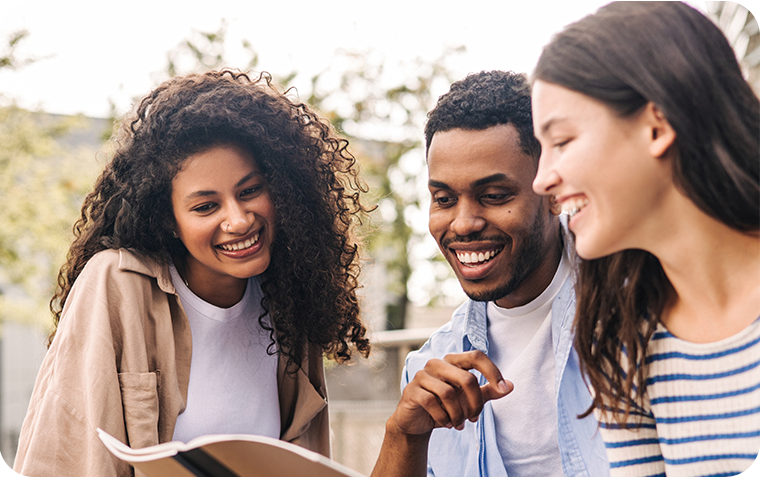 Young adults looking at a book