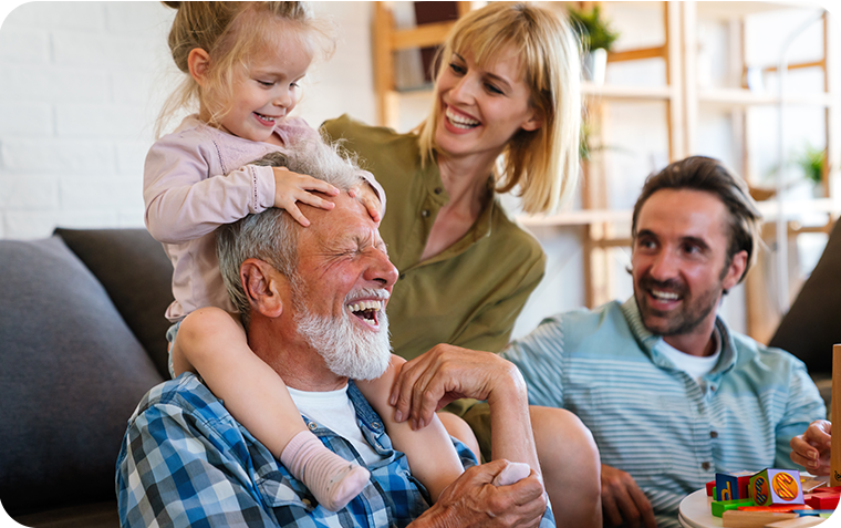Cheerful grandfather with children and grandchild playing on couch