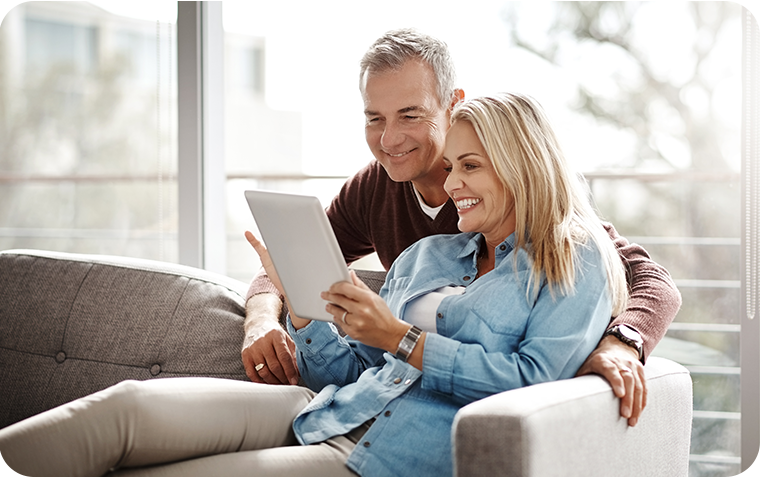 Middle aged couple reading on couch