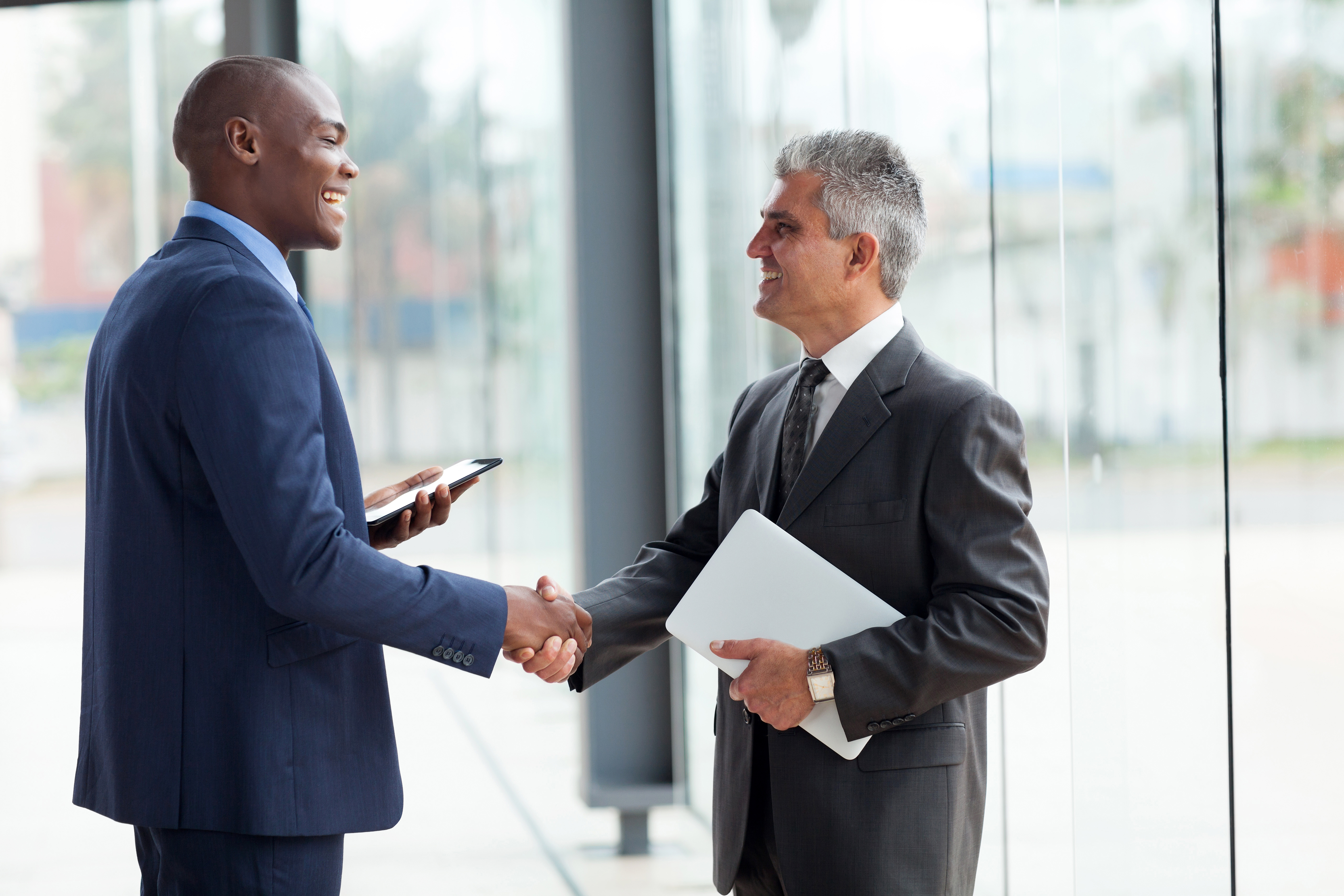 Two men in suits shaking hands