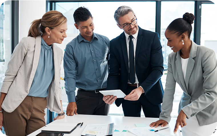 Executive speaking with team members in office
