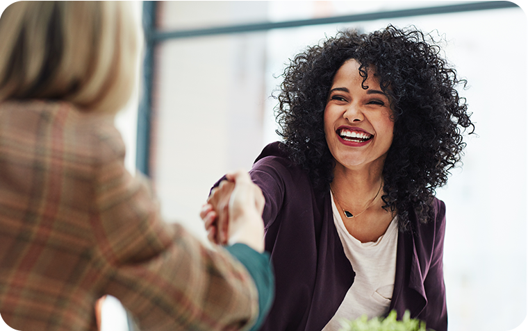 Business woman shaking colleagues hand
