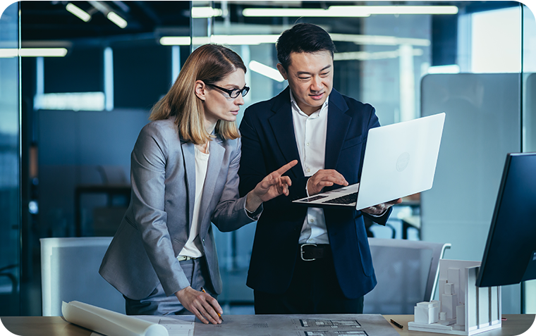 Businesspeople looking at laptop